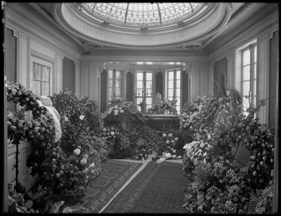 Unidentified funeral chapel interior with casket and flowers, decorated for Octavio Davis by William Davis Hassler